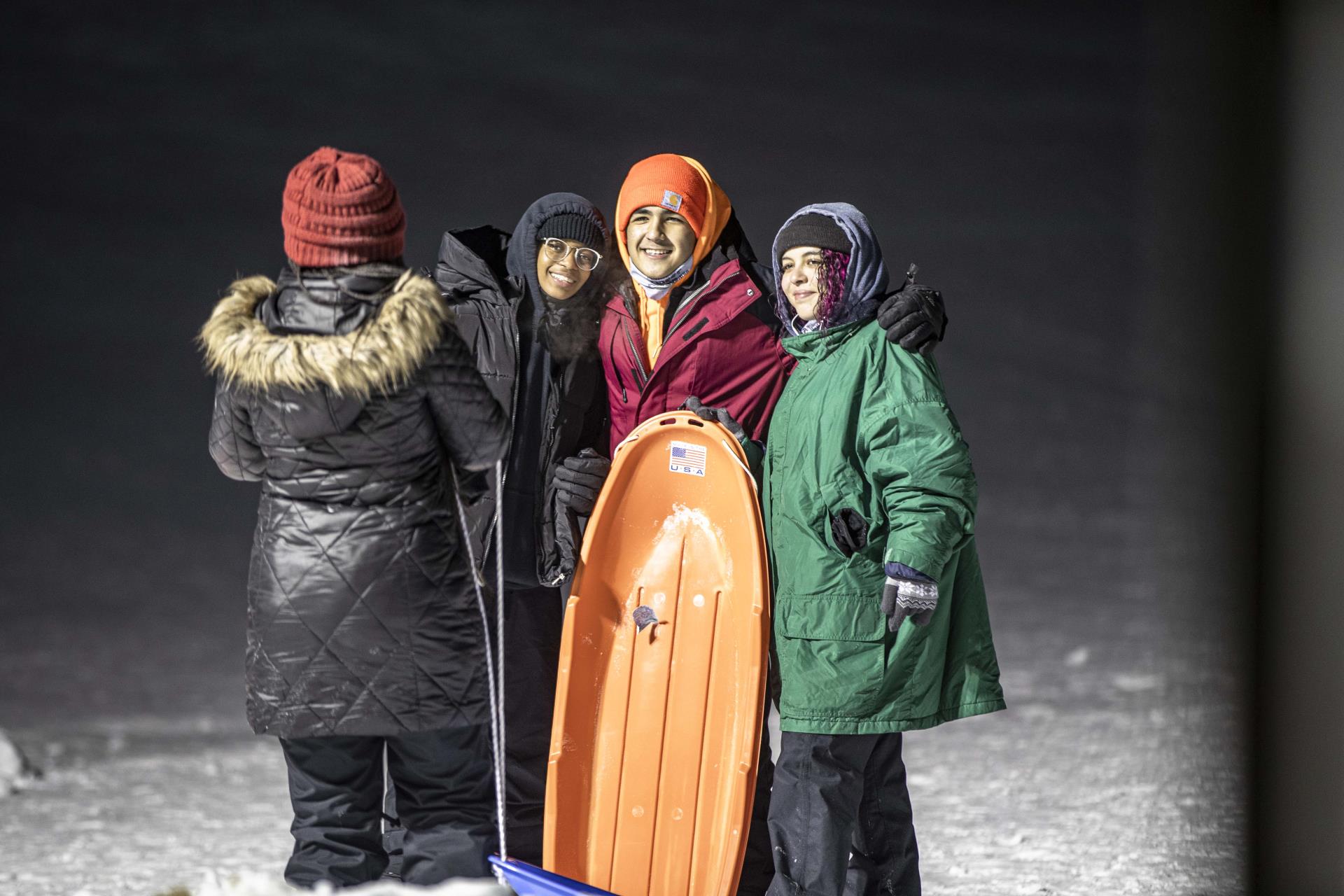 Friends sledding at Maryland Creek Park